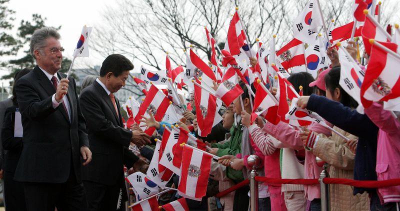 [오스트리아 피셔 대통령 공식환영식에서 환영하는 어린이들에게 국기를 흔들며 인사하는 양국 정상]