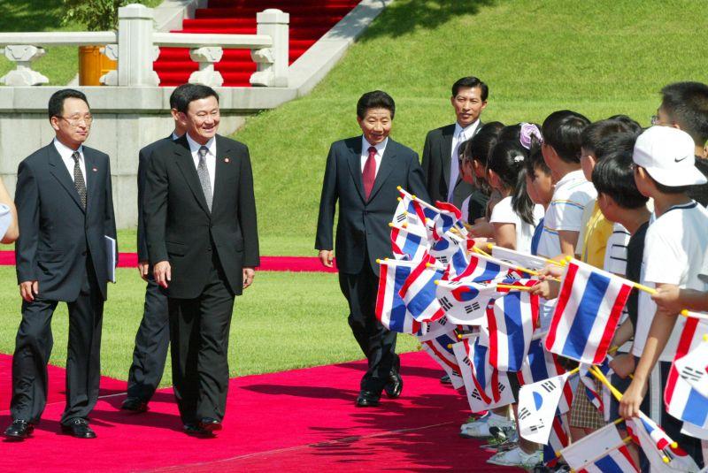 [공식환영식에서 양국 국기를 흔들며 환영하는 어린이들에게 인사하는 탁신 치나왓 총리와 노무현 대통령]