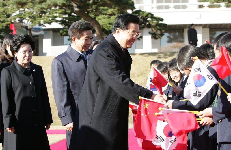 [공식환영식에서 양국 국기를 흔드는 어린이들과 인사하는 후진타오 중국 국가주석과 노무현 대통령]